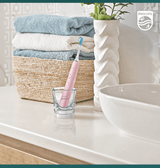 Bathroom scene with a pink Sonicare toothbrush
